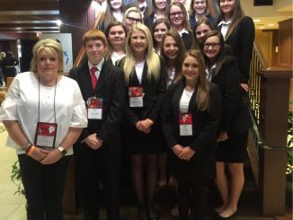 HOSA students shown dressed for awards with adviser.