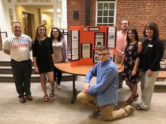 Biomedical students shown with their exhibit from the internship at Union College.