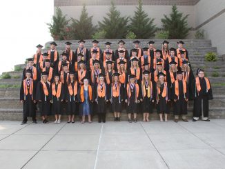 Lynn Camp graduates pose in front of the school for one final picture opportunity before graduation.
