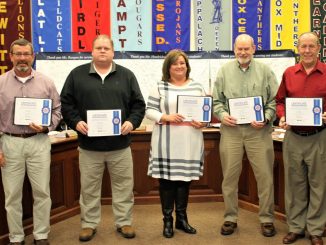 Board members are shown holding a certificate from the Kentucky School Boards Association as part of school board recognition month.