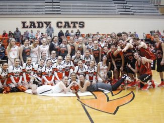 Players and cheerleaders gathered at center court for a photo opportunity during Meet the Cats.