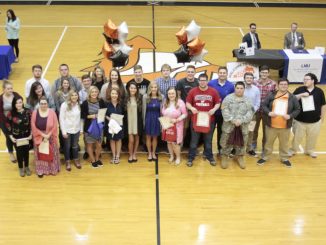 Students shown at College Signing Day at Lynn Camp with gifts and awards
