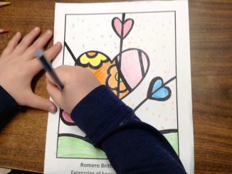 A student is shown coloring a photo using pop art techniques.
