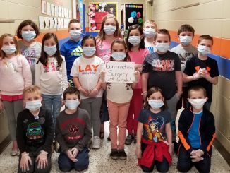 Lay students dressed as surgeons to perform word surgery on two words to create the contraction.