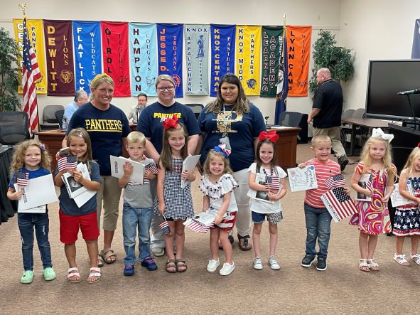 Central Elementary kindergarten students standing with flags after reciting the pledge.